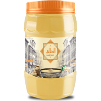 عبوة طحينة الظاهر 400 جرام بلون أصفر ذهبي وغطاء برتقالي، يظهر على الملصق شعار "الظاهر – طحينة مصرية" مع رسم لشارع مصري قديم، وصورة طبق طحينة مصنوعة من سمسم طبيعي 100٪.

Al Zaher Tahini jar 400 gm in golden yellow with an orange cap, featuring the “Al Zaher – Egyptian Tahini” logo and artwork of an old Egyptian street, along with an image of a tahini bowl made from 100% natural sesame seeds.