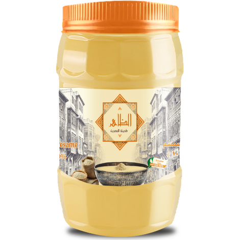 عبوة طحينة الظاهر 400 جرام بلون أصفر ذهبي وغطاء برتقالي، يظهر على الملصق شعار "الظاهر – طحينة مصرية" مع رسم لشارع مصري قديم، وصورة طبق طحينة مصنوعة من سمسم طبيعي 100٪.
Al Zaher Tahini jar 400 gm in golden yellow with an orange cap, featuring the “Al Zaher – Egyptian Tahini” logo and artwork of an old Egyptian street, along with an image of a tahini bowl made from 100% natural sesame seeds. عبوة طحينة الظاهر 400 جرام بلون أصفر ذهبي وغطاء برتقالي، يظهر على الملصق شعار "الظاهر – طحينة مصرية" مع رسم لشارع مصري قديم، وصورة طبق طحينة مصنوعة من سمسم طبيعي 100٪.
Al Zaher Tahini jar 400 gm in golden yellow with an orange cap, featuring the “Al Zaher – Egyptian Tahini” logo and artwork of an old Egyptian street, along with an image of a tahini bowl made from 100% natural sesame seeds.